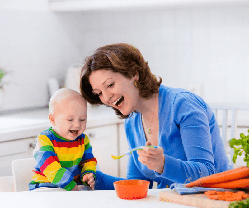 Mom feeding baby with spoon